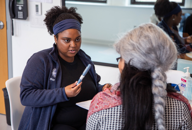 A nursing student doing a mock consulatation in a home health setting