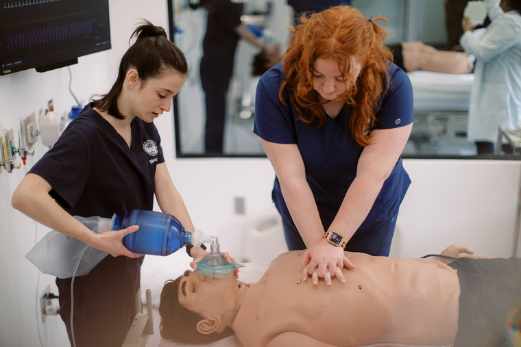 Students simulating giving CPR to a patient in the Nursing Simulation Center