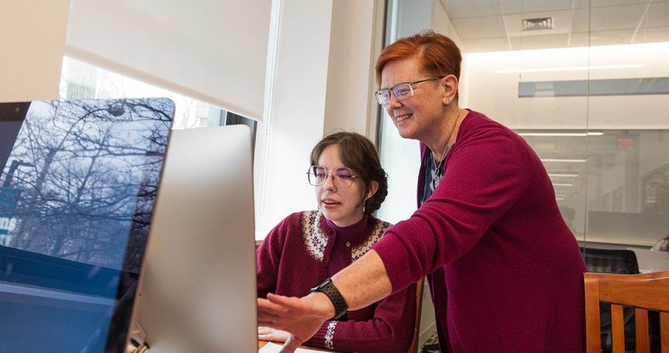 A Library and Information Science faculty member working with a student