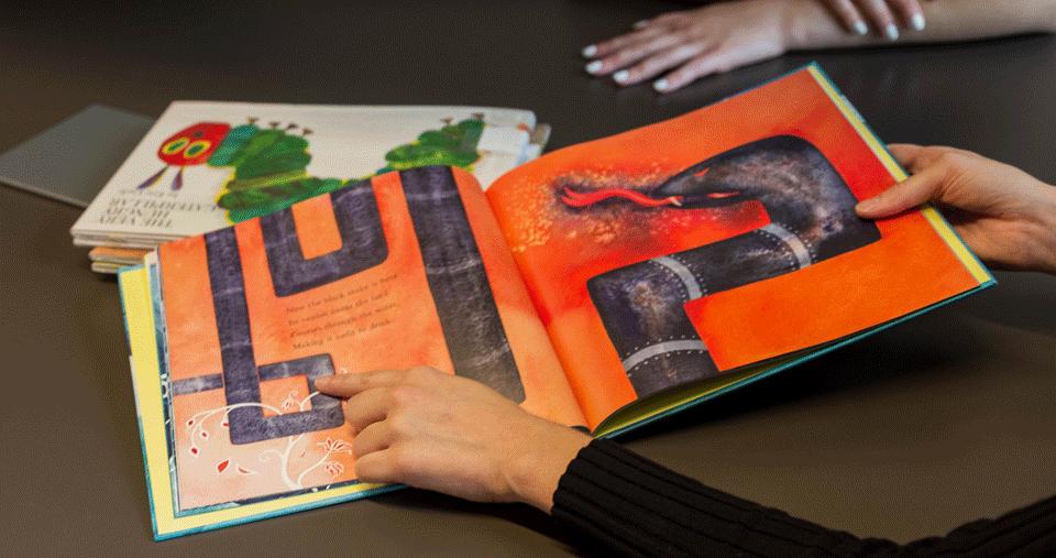 An assortment of children's books lying on a table