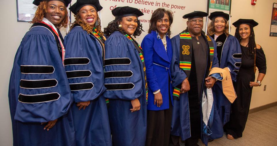 Doctoral Graduates lined up with President Wooten and others 