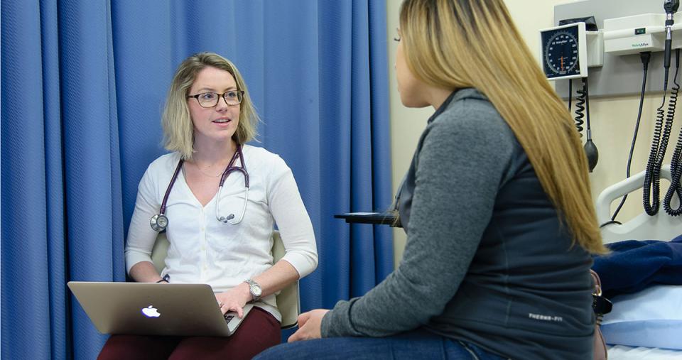 A Simmons nursing student conducting a patient interview