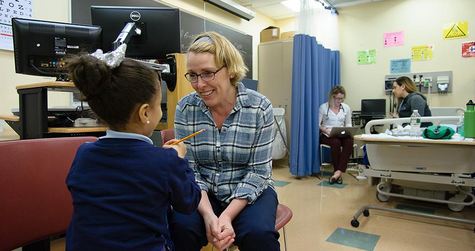 Nursing student working with child